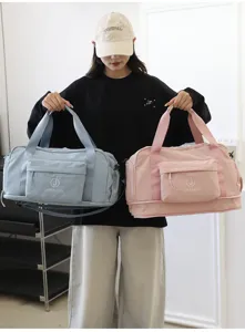 Detail view of large capacity waterproof travel duffel bag with front pocket and dual handles.