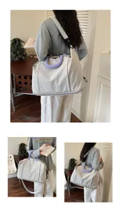 Large capacity travel duffel bag detail showing canvas body, purple handles, and strap.