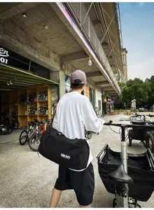 Detailed view of a black large capacity travel duffel bag in an outdoor street setting