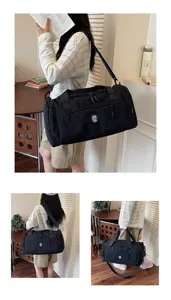 Detailed view of the black travel duffel bag showcasing side pockets and shoulder strap.