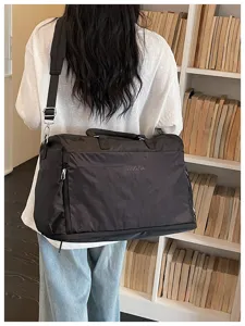 Large capacity travel duffel bag for short trips, portable shoulder bag with durable fabric.