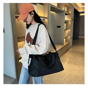 Black oxford cloth duffel bag detail, large capacity waterproof travel fitness bag for women.