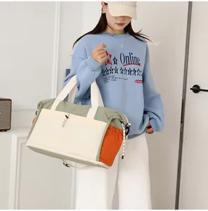 Detailed shot of large capacity travel duffel shoulder bag with multi-color design for women.