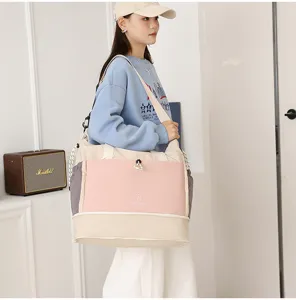 Expandable large capacity travel shoulder bag in stylish colorblock design for weekend trips.