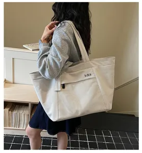 Casual canvas tote bag with mesh pocket, large capacity shoulder bag for daily commute.