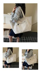 Casual canvas tote bag with mesh pocket and letter print, perfect for daily commuting and travel.