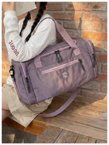 Purple waterproof travel duffel bag with shoulder strap and multiple zipper compartments.