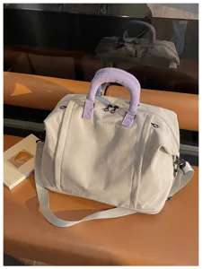 Large capacity travel duffel bag for women, lightweight waterproof weekender bag with shoulder strap.