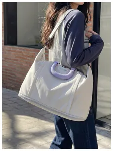 Large capacity travel shoulder bag for women, waterproof weekend overnight duffel bag.