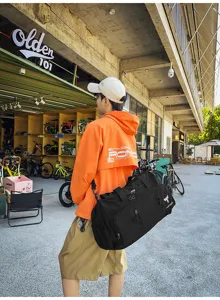 Large capacity black nylon travel duffel bag for sports and short trips, multi-use.