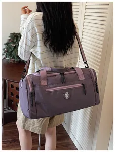 Waterproof travel duffel bag with shoulder strap, large capacity storage for daily use.