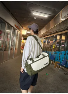 Large capacity duffel travel bag with crossbody strap, lightweight and versatile for sports.