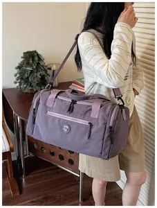 Waterproof travel duffel bag for women, large capacity foldable gym shoulder bag for outdoor trip.