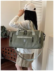 Detailed shot of the large army green travel duffel bag with shoulder strap and durable fabric.