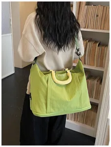 Large capacity green travel shoulder bag detail view, lightweight and expandable design.
