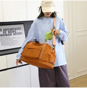 Large capacity waterproof travel duffel bag, detailed view of durable fabric and shoulder strap.