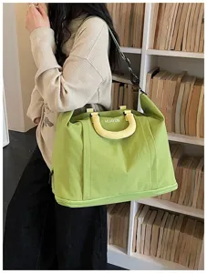 Large capacity canvas travel bag with yellow handles, perfect for short trips and daily commuting.