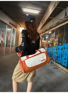 Large capacity travel duffel bag with crossbody strap, lightweight design for outdoor trips.