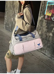 Detail shot of multi-functional nylon travel duffel bag with pink grey color block and straps.