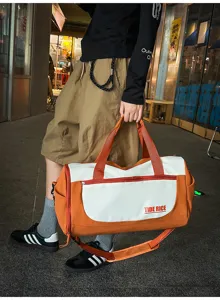 Large capacity travel duffel bag with wet dry separation, orange and white color block.