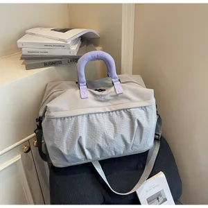 Large capacity travel gym bag with extended design, stylish purple handle and grid pattern.