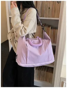 Large capacity travel duffel bag for women, lightweight waterproof expandable shoulder bag.