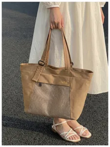 Casual waterproof canvas tote bag with mesh pocket for women commuting, travel and daily use.