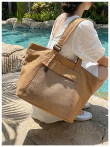 Large capacity canvas tote bag with front mesh pocket and adjustable strap for daily commute.