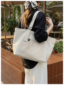 Large capacity commuter tote bag, casual canvas shoulder bag with front mesh pocket for daily use.