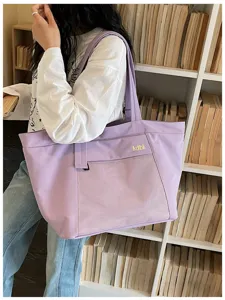 Detailed view of purple casual tote bag featuring front mesh pocket and chic letter print.