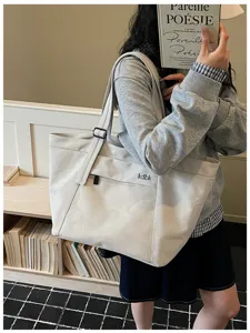 Casual canvas tote bag with front mesh pocket and minimalist style for daily commute.
