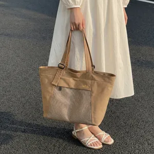 Khaki canvas tote bag with front mesh pocket, stylish large capacity commuter handbag for women.