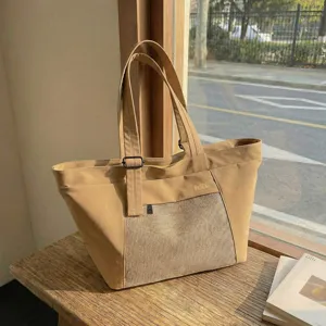 Casual canvas tote bag for women, large capacity commute shoulder bag with mesh pocket.