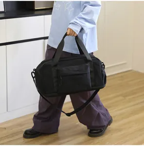 Black waterproof travel duffel bag with shoulder strap, large capacity gym sports luggage.