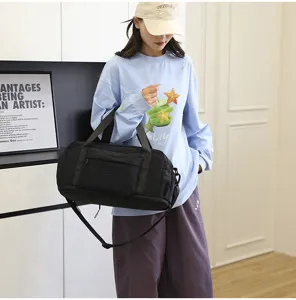 Black waterproof travel duffel bag for men and women, perfect for fitness and weekend trips.