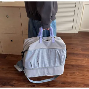 Detailed view of the expandable travel fitness duffel bag handle and grid pattern compartment.