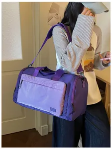 Waterproof travel duffel bag for fitness and short trips with large capacity in purple color.