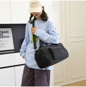 Detail shot of black travel duffel bag with shoulder strap, durable fabric in lifestyle.