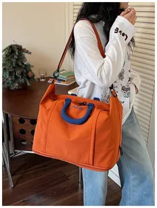 Large capacity travel duffel bag for women, waterproof lightweight shoulder weekend luggage bag.