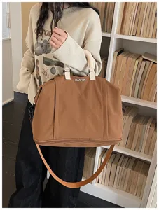 Large capacity brown travel duffel bag detail view, expandable shoulder strap design.