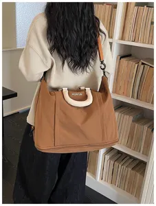Large capacity travel duffel bag for women, waterproof expandable weekend luggage shoulder bag.