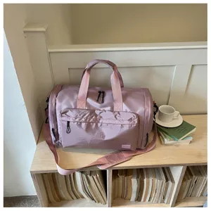 Detail view of the pink travel gym bag with dry wet separation in a cozy lifestyle setting.