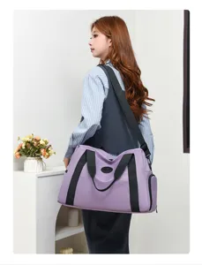 Detail view of a stylish light purple travel duffel bag with shoulder strap and large capacity.