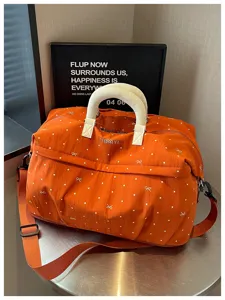 Expandable travel duffel bag with stylish polka dot and bow print, ideal for fitness and trips.