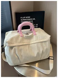 Detailed view of the stylish travel bag featuring pink polka dots and cute bow accents.