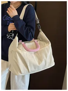 Detailed view of the large expandable travel duffel bag featuring cute pink bow print.