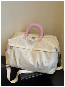 Expandable travel duffle bag with cute pink dots and bow print, perfect for weekend trips.