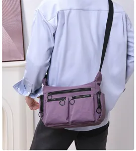 Multi-pocket commuter messenger bag, casual utility crossbody bag with zip pockets and rings.