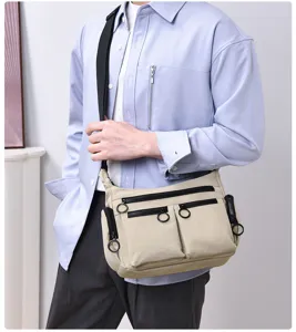 Multi-pocket crossbody utility bag with smooth zippers, showing casual canvas material details.