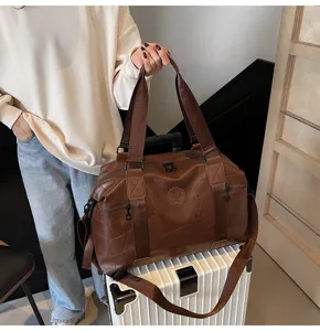 Waterproof large capacity travel duffel bag in brown leather, perfect for gym and weekend trips.